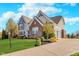 Well-maintained two-story home with attached garage and landscaped front yard at 3728 Dunellen Cir, Carmel, IN 46074