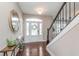 Inviting foyer with hardwood floors, staircase, and decorative mirror at 3728 Dunellen Cir, Carmel, IN 46074
