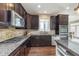 A kitchen showcasing granite counters, stone backsplash, and stainless steel appliances at 3728 Dunellen Cir, Carmel, IN 46074