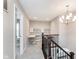 Bright landing area featuring an open staircase, built-in shelving and desk, and neutral carpeting at 3728 Dunellen Cir, Carmel, IN 46074