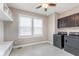 Laundry room featuring dark cabinets, ample shelving, and a front-load washer and dryer at 3728 Dunellen Cir, Carmel, IN 46074
