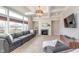 Living room featuring coffered ceilings, a fireplace, and oversized windows at 3728 Dunellen Cir, Carmel, IN 46074
