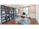 Spacious home office with custom built-ins, hardwood floors and large window at 3728 Dunellen Cir, Carmel, IN 46074