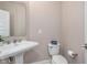 A powder room with a pedestal sink and a white toilet at 3728 Dunellen Cir, Carmel, IN 46074