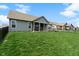 A view of the home's rear exterior and covered patio, surrounded by a fenced backyard at 3971 Albert Ln, Bargersville, IN 46106