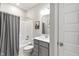 Well-lit bathroom with a shower-tub combo, gray vanity, and a framed mirror at 3971 Albert Ln, Bargersville, IN 46106