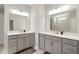 This bathroom features a dual sink vanity with modern lighting, sleek hardware, and mirrors for a contemporary feel at 3971 Albert Ln, Bargersville, IN 46106