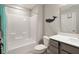 This bathroom features a bathtub with shower, whale wall decor, and a modern vanity for a clean and stylish look at 3971 Albert Ln, Bargersville, IN 46106