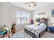 bedroom featuring a bed with dinosaur-themed bedding, a ceiling fan, and lots of toys at 3971 Albert Ln, Bargersville, IN 46106