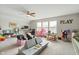 This bonus room features a ceiling fan and is currently arranged as a playroom with an assortment of toys and decor at 3971 Albert Ln, Bargersville, IN 46106