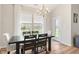Well-lit dining area featuring hardwood floors, a chandelier, and access to the outdoor space at 3971 Albert Ln, Bargersville, IN 46106