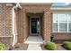 A welcoming entryway to this brick home with a decorative wreath on the door and lush landscaping at 3971 Albert Ln, Bargersville, IN 46106