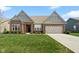 Charming brick home featuring a manicured lawn, attached two-car garage and a beautiful blue sky at 3971 Albert Ln, Bargersville, IN 46106