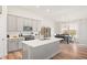 Modern kitchen with stainless steel appliances, island with a sink, and open to the dining area at 3971 Albert Ln, Bargersville, IN 46106