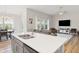 Open-concept design with kitchen island featuring a double sink, blending into the living area for seamless flow at 3971 Albert Ln, Bargersville, IN 46106