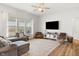 Bright, open living room features hardwood floors, a ceiling fan, and a large window for ample natural light at 3971 Albert Ln, Bargersville, IN 46106