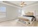 This main bedroom has a bright atmosphere, a tray ceiling, and is decorated with an elegant, upholstered bed at 3971 Albert Ln, Bargersville, IN 46106