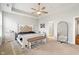 The main bedroom features a tray ceiling, a ceiling fan, and a large decorative mirror for added style and functionality at 3971 Albert Ln, Bargersville, IN 46106
