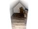 An unfinished attic space with wood-look flooring, and a large pile of moving boxes stacked along the back wall at 4029 W Fairview Rd, Greenwood, IN 46142