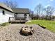 Backyard featuring a fire pit, gravel, and a wooden deck attached to the home at 4029 W Fairview Rd, Greenwood, IN 46142