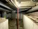 Unfinished basement with exposed pipes, brick walls, and a concrete floor at 4029 W Fairview Rd, Greenwood, IN 46142