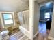 Classic bathroom with tiled walls, shower with curtain and view into the bedroom at 4029 W Fairview Rd, Greenwood, IN 46142