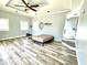 Bedroom with light blue walls, wood-look floors, and a ceiling fan at 4029 W Fairview Rd, Greenwood, IN 46142