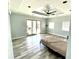 A light blue bedroom featuring a sliding glass door, ceiling fan and trey ceiling at 4029 W Fairview Rd, Greenwood, IN 46142