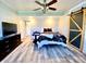 Light and airy bedroom with a modern barn door, ceiling fan, and hardwood flooring at 4029 W Fairview Rd, Greenwood, IN 46142