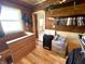 A rustic closet space with wood paneling, shelves, and a window offering a view into an adjacent bedroom at 4029 W Fairview Rd, Greenwood, IN 46142