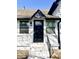 A freshly painted front door with black trim, black hardware, and a brick paver walkway at 4029 W Fairview Rd, Greenwood, IN 46142