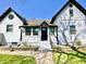 Front entrance of home with black door, painted brick accents, and small landscaped space at 4029 W Fairview Rd, Greenwood, IN 46142