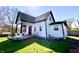 Charming home with black trim, bay window, white siding, landscaping, and a green lawn at 4029 W Fairview Rd, Greenwood, IN 46142