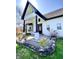 A beautifully landscaped front porch with stone accents, columns and manicured plantings at 4029 W Fairview Rd, Greenwood, IN 46142