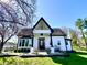 Charming two-story home with black and white trim, landscaped yard, and a clear blue sky at 4029 W Fairview Rd, Greenwood, IN 46142