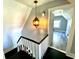 A well-lit hallway with decorative hanging lights leading into a bedroom with new flooring at 4029 W Fairview Rd, Greenwood, IN 46142