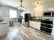 Spacious kitchen with stainless steel appliances, granite countertops and modern lighting at 4029 W Fairview Rd, Greenwood, IN 46142