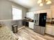 Bright kitchen with stainless steel appliances, granite countertops and modern lighting at 4029 W Fairview Rd, Greenwood, IN 46142