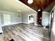 Spacious living room featuring hardwood flooring and an open view to the fireplace at 4029 W Fairview Rd, Greenwood, IN 46142