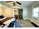 Main bedroom features a barn door to the bathroom, light gray walls and luxury vinyl flooring at 4029 W Fairview Rd, Greenwood, IN 46142