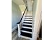 Newly renovated stairway with black and white painted stairs, gray walls, and white trim at 4029 W Fairview Rd, Greenwood, IN 46142