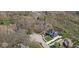 Aerial view showcasing a house in a lush, wooded neighborhood at 4312 S Woodbridge Ln, New Palestine, IN 46163