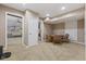 Basement game area with a card table and view into a seating area with a couch at 4312 S Woodbridge Ln, New Palestine, IN 46163