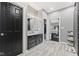 This bathroom showcases a stone shower, a modern vanity and a walk-in closet for ultimate convenience at 4312 S Woodbridge Ln, New Palestine, IN 46163
