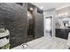 This bathroom showcases a stone shower, double sinks, and a bathtub for a relaxing experience at 4312 S Woodbridge Ln, New Palestine, IN 46163