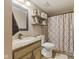 Bathroom with granite vanity, decorative mirror and shower with patterned curtain at 4312 S Woodbridge Ln, New Palestine, IN 46163