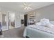 Bedroom featuring a ceiling fan, carpet flooring, and an adjoining bath at 4312 S Woodbridge Ln, New Palestine, IN 46163