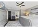 This primary suite features a large bed, a bathroom with a shower and wood floors at 4312 S Woodbridge Ln, New Palestine, IN 46163