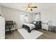 This bedroom features a bed with a white rug, a ceiling fan, and a window at 4312 S Woodbridge Ln, New Palestine, IN 46163