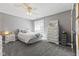 Comfortable bedroom with a ceiling fan, plush carpeting, and a side table at 4312 S Woodbridge Ln, New Palestine, IN 46163